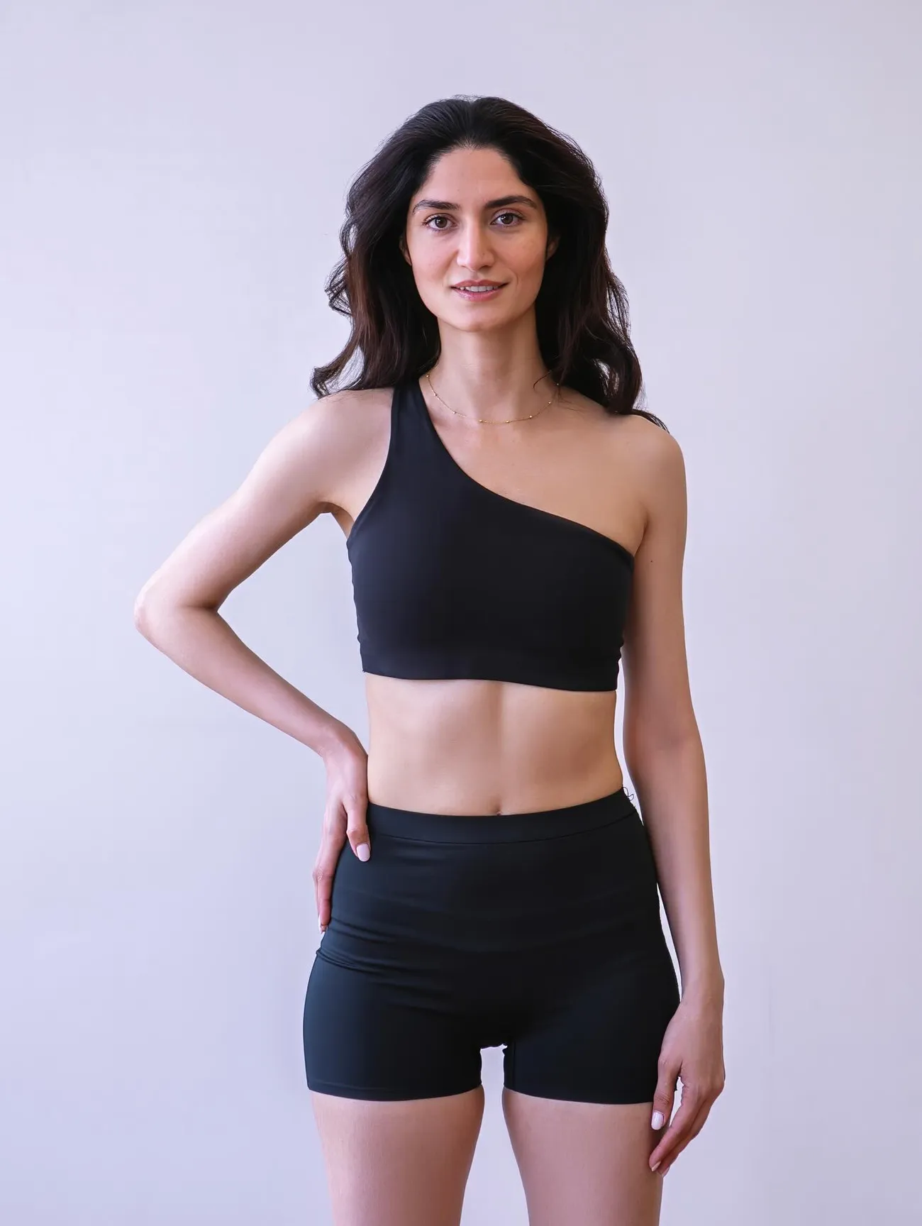 Toktam standing in the studio, one hand on her hip